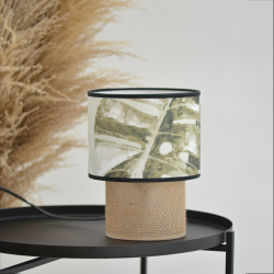 Lampe à poser TABATA jungle tropicale mise en scène sur une console noire dans un décor végétal